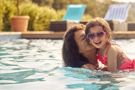 mother and daughter playing in the pool